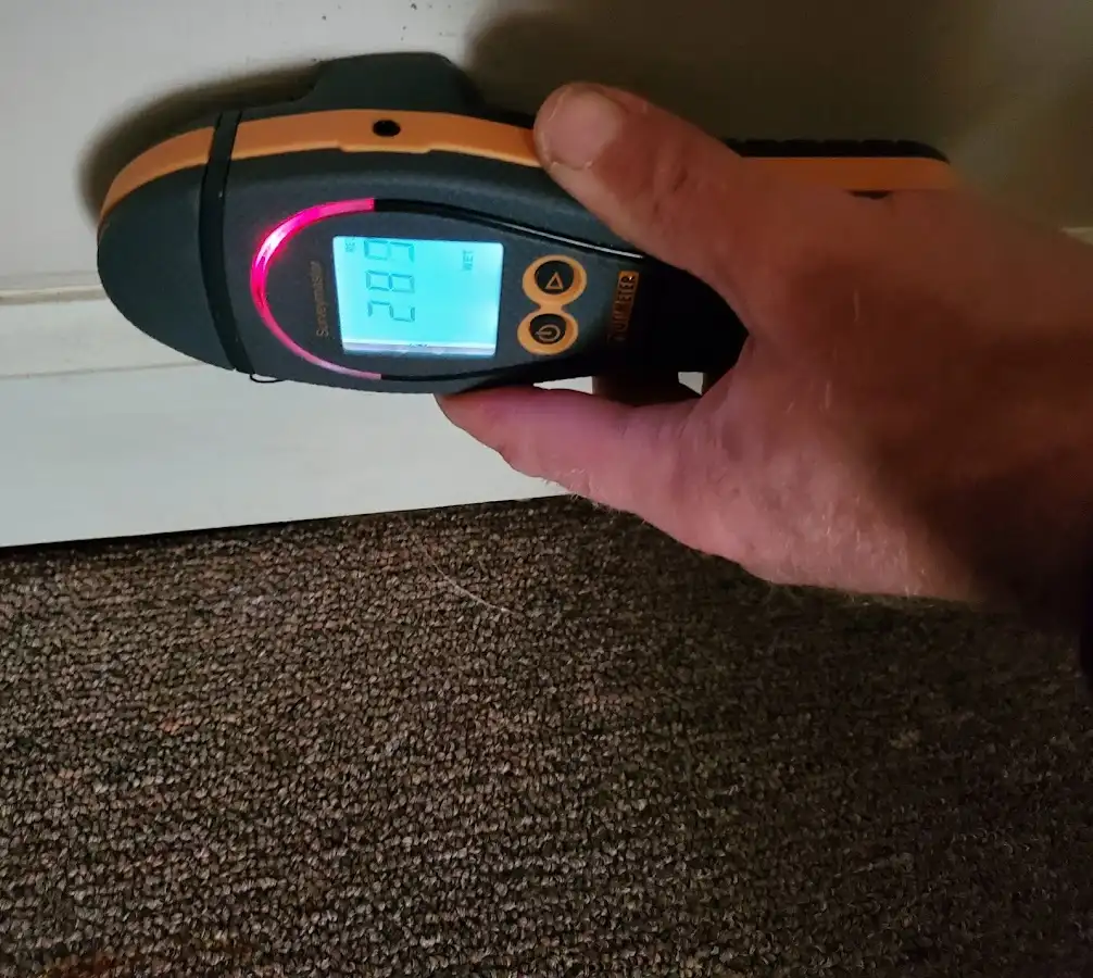 Moisture detection at baseboard during Storm Damage Restoration in New Square